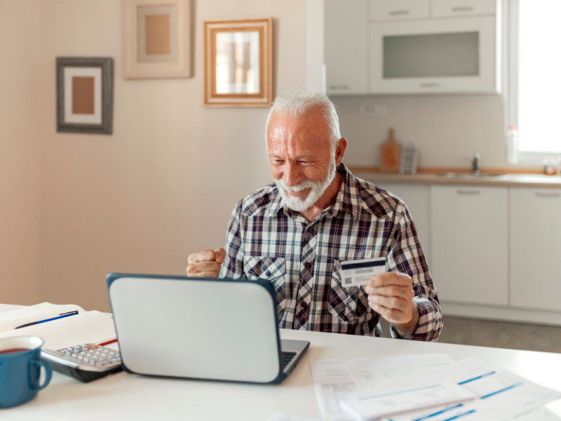 Elder man logs in to online payment services. 