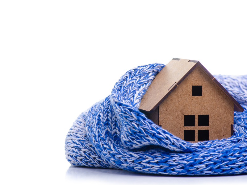 Model of a house wrapped in a scarf.