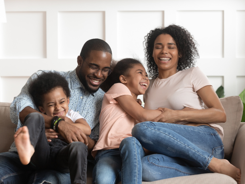 Happy family play on a couch.