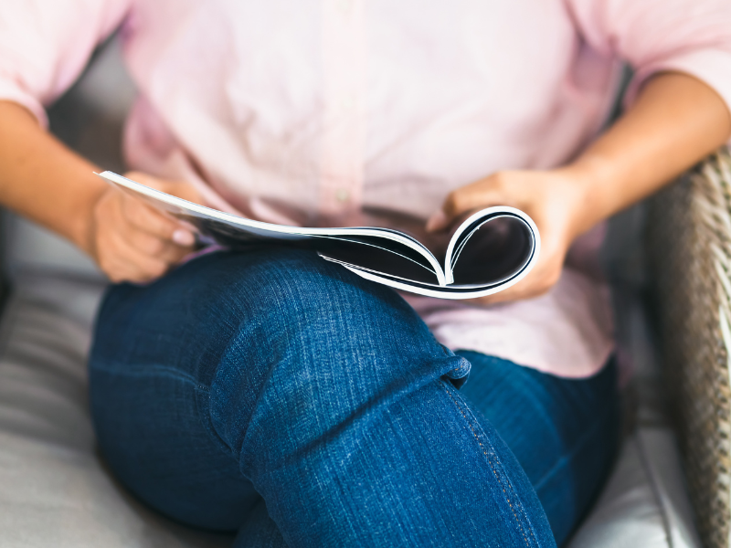 A woman reads a magazine.